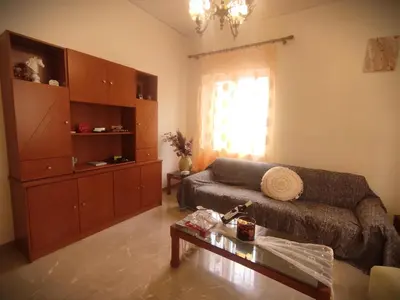 a living room with a couch and a coffee table at Anastasia's Cozy Retreat in Ialyssos