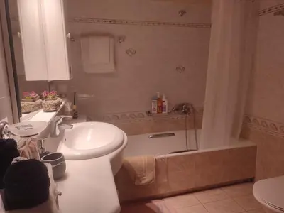 a bathroom with a sink and a toilet and a shower at Anastasia's Cozy Retreat in Ialyssos