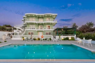 a villa with a swimming pool in front of a house at Nimo Paradise Estate in Paradeísion