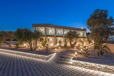 a building with lights in front of it at night at Tota Suites in Afantou