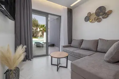 a living room with a couch and a table at Tota Suites in Afantou