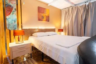 a bedroom with a bed and a table with a lamp at La Terrazza Sul Mare in Rhodes Town