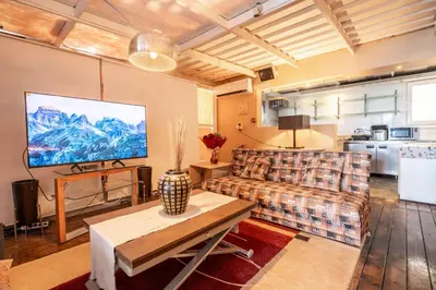 a living room with a couch and a tv at La Terrazza Sul Mare in Rhodes Town