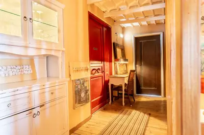 a kitchen with a red door and a table at La Terrazza Sul Mare in Rhodes Town
