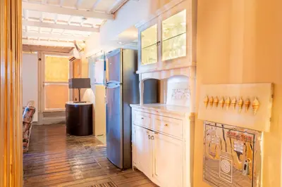 a kitchen with a refrigerator and a table in a room at La Terrazza Sul Mare in Rhodes Town