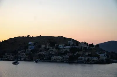 a village on top of a hill in the water at Bella Vista II in Symi