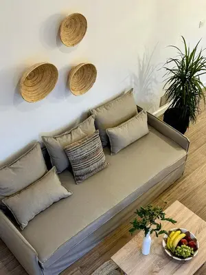 a couch in a living room with pillows and a table at Bella Vista II in Symi