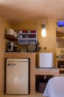 a small kitchen with a counter and a sink at kalosymi studio, Symi in Symi