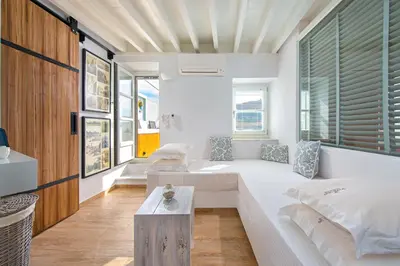 a living room with a couch and a table at Lindos Allure Villa with Jacuzzi and Acropolis view!!! in Líndos