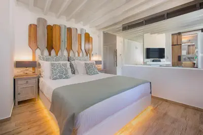 a bedroom with a large bed with surfboards on the wall at Lindos Allure Villa with Jacuzzi and Acropolis view!!! in Líndos