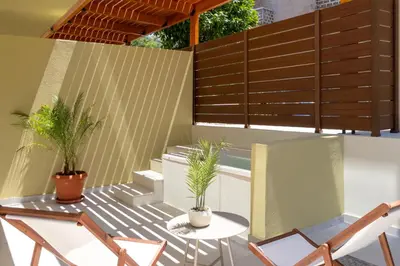 a patio with chairs and a table with plants at Açai Plant Based Hotel in Rhodes Town