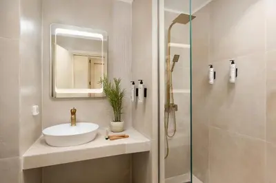 a bathroom with a sink and a shower at Açai Plant Based Hotel in Rhodes Town