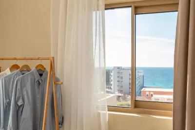 a room with a window with a view of the ocean at Açai Plant Based Hotel in Rhodes Town
