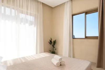 a bedroom with a bed with two towels on it at Açai Plant Based Hotel in Rhodes Town