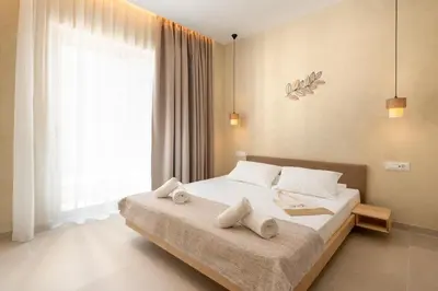 a bedroom with a large bed with towels on it at Açai Plant Based Hotel in Rhodes Town