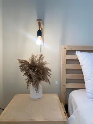 a table with a plant on it next to a bed at Bohemian Paradise Villa in Paradeísion