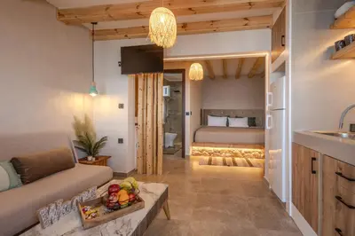 a living room with a couch and a bed at Diamond Seaview Stegna in Archangelos
