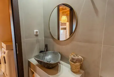 a bathroom with a sink and a mirror at Diamond Seaview Stegna in Archangelos