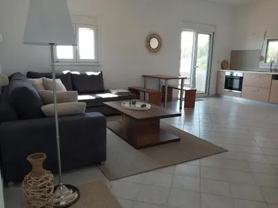 a living room with a couch and a table at Marias Apartment in Kolimbia