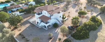 an overhead view of a large white house with a roof at Marias Apartment in Kolimbia