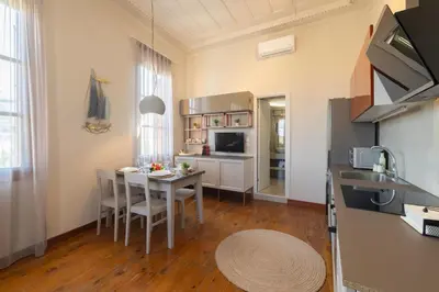 a kitchen and dining room with a table and chairs at Ladino Old Town in Rhodes Town