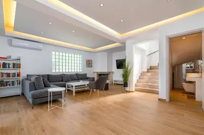 a living room with a couch and a table at Villa Dana by Villa Plus in Ialyssos