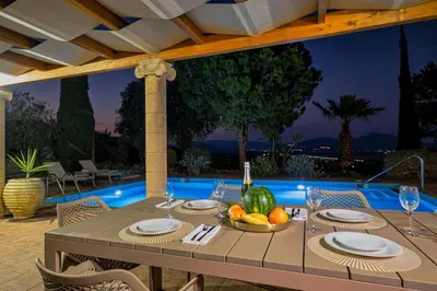 a table with a bowl of fruit sitting on a patio at Villa Lavanda, panoramic view! in Kalathos