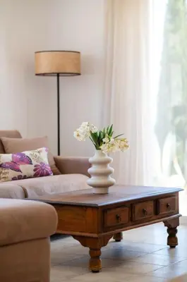 a living room with a coffee table with flowers on it at Villa Lavanda, panoramic view! in Kalathos