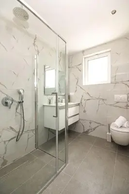 a bathroom with a shower and a toilet and a sink at Villa Lavanda, panoramic view! in Kalathos
