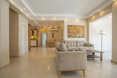 a living room with a couch and a table at Escape In View Villa Rhodes in Pastida