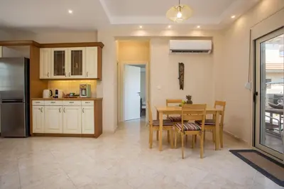 a kitchen and dining room with a table and chairs at Escape In View Villa Rhodes in Pastida