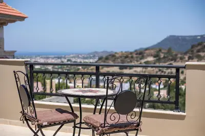 a table and chairs on a balcony with a view at Escape In View Villa Rhodes in Pastida
