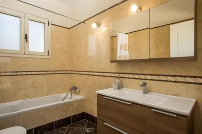 a bathroom with a sink and a bath tub at Escape In View Villa Rhodes in Pastida
