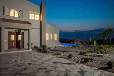 a large white house with a stone patio at Escape In View Villa Rhodes in Pastida