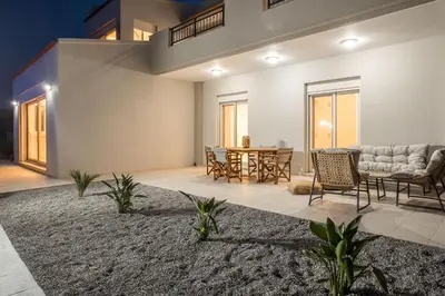 a living room with a table and chairs at Escape In View Villa Rhodes in Pastida