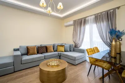 a living room with a couch and a table at J O House in Archangelos