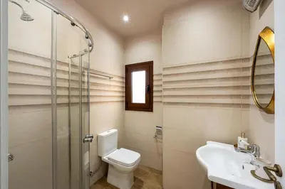 a bathroom with a toilet and a sink and a shower at J O House in Archangelos