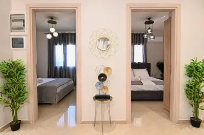 a room with a bedroom with a bed and a mirror at Harmony Garden House in Ialyssos