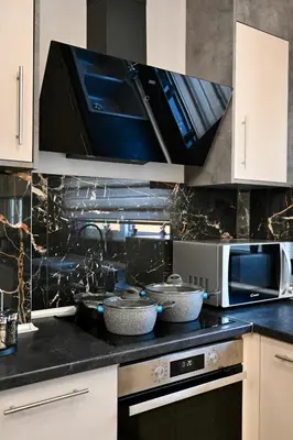 a kitchen with a stove and a microwave at Harmony Garden House in Ialyssos