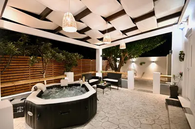 a hot tub in the middle of a patio at Harmony Garden House in Ialyssos