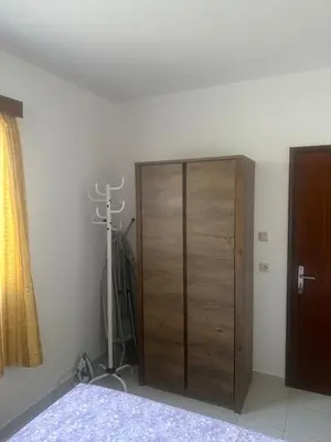 a bedroom with a wooden cabinet and a camera at KakLeCharaki in Haraki