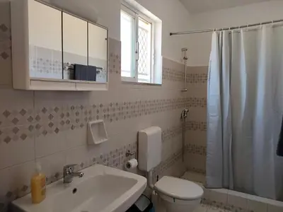 a bathroom with a sink and a toilet and a shower at KakLeCharaki in Haraki