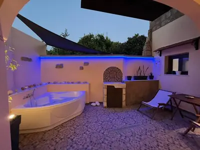 a large bathroom with a tub and a table at Mirodaty's House in Rhodes Town