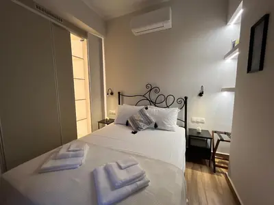 a bedroom with a white bed with two towels on it at Mirodaty's House in Rhodes Town