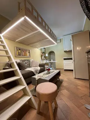 a living room with a loft bed and a kitchen at The Old Town Hideaway in Rhodes Town