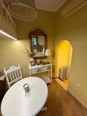 a room with a white table and a mirror at The Old Town Hideaway in Rhodes Town