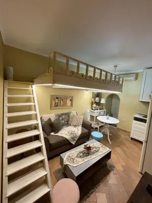 a living room with a loft bed and a couch at The Old Town Hideaway in Rhodes Town