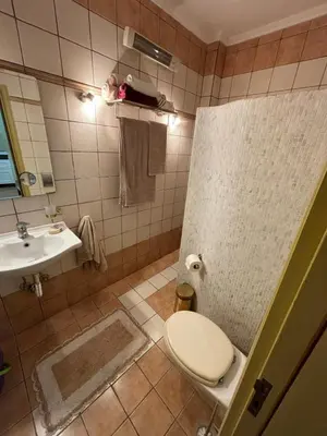 a bathroom with a toilet and a sink at The Old Town Hideaway in Rhodes Town