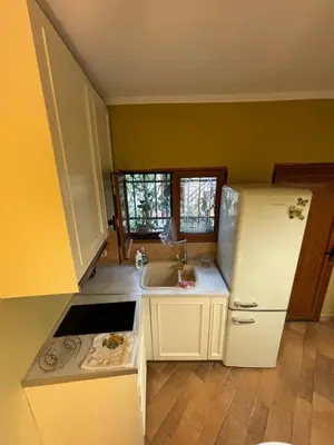 a kitchen with a white refrigerator and a sink at The Old Town Hideaway in Rhodes Town