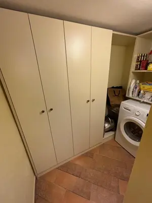 a laundry room with white cabinets and a washing machine at The Old Town Hideaway in Rhodes Town